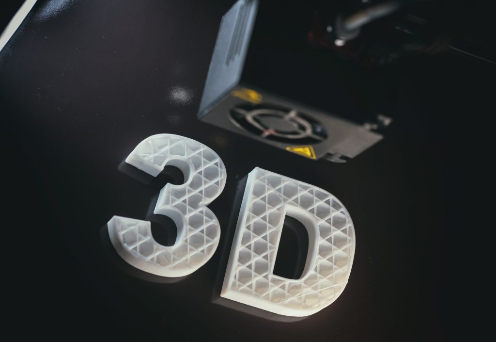 3D printers. 3D text white color ABS against black background,