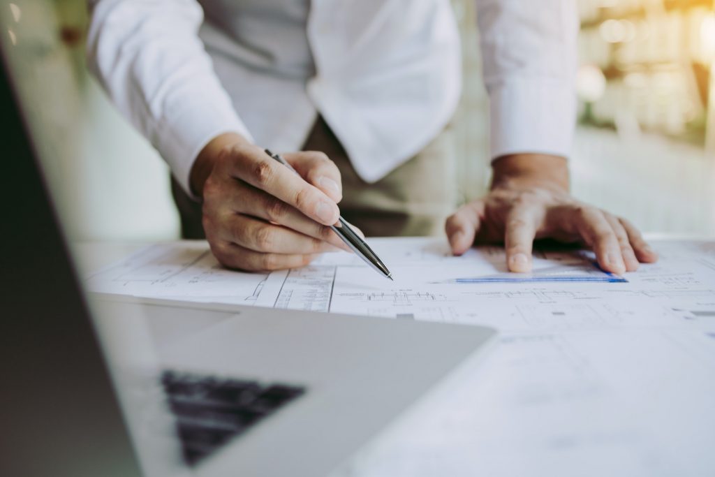 Engineers are helping to design work on blueprints and collaborate on structural